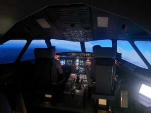 Nuori aikuinen lentämässä Airbus A320-simulaattorilla.